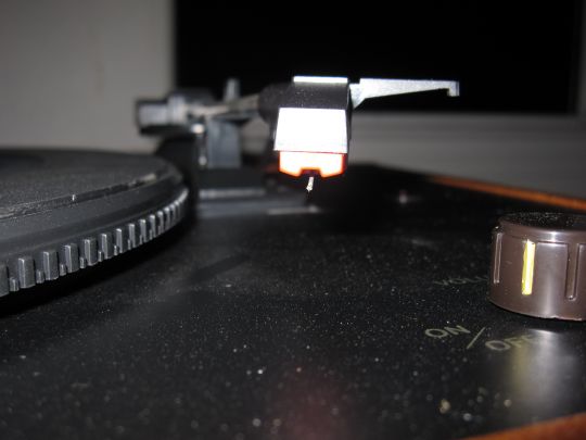 Close up photo shows the stylus (needle) and cartridge of the Crosley CR249 turntable.