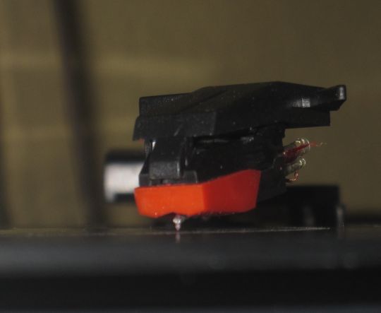 Close-up photo shows the style playing a record on the Grace Digital Audio Vinylwriter USB turntable. A fine dust is visible in the vicinity of the needle.